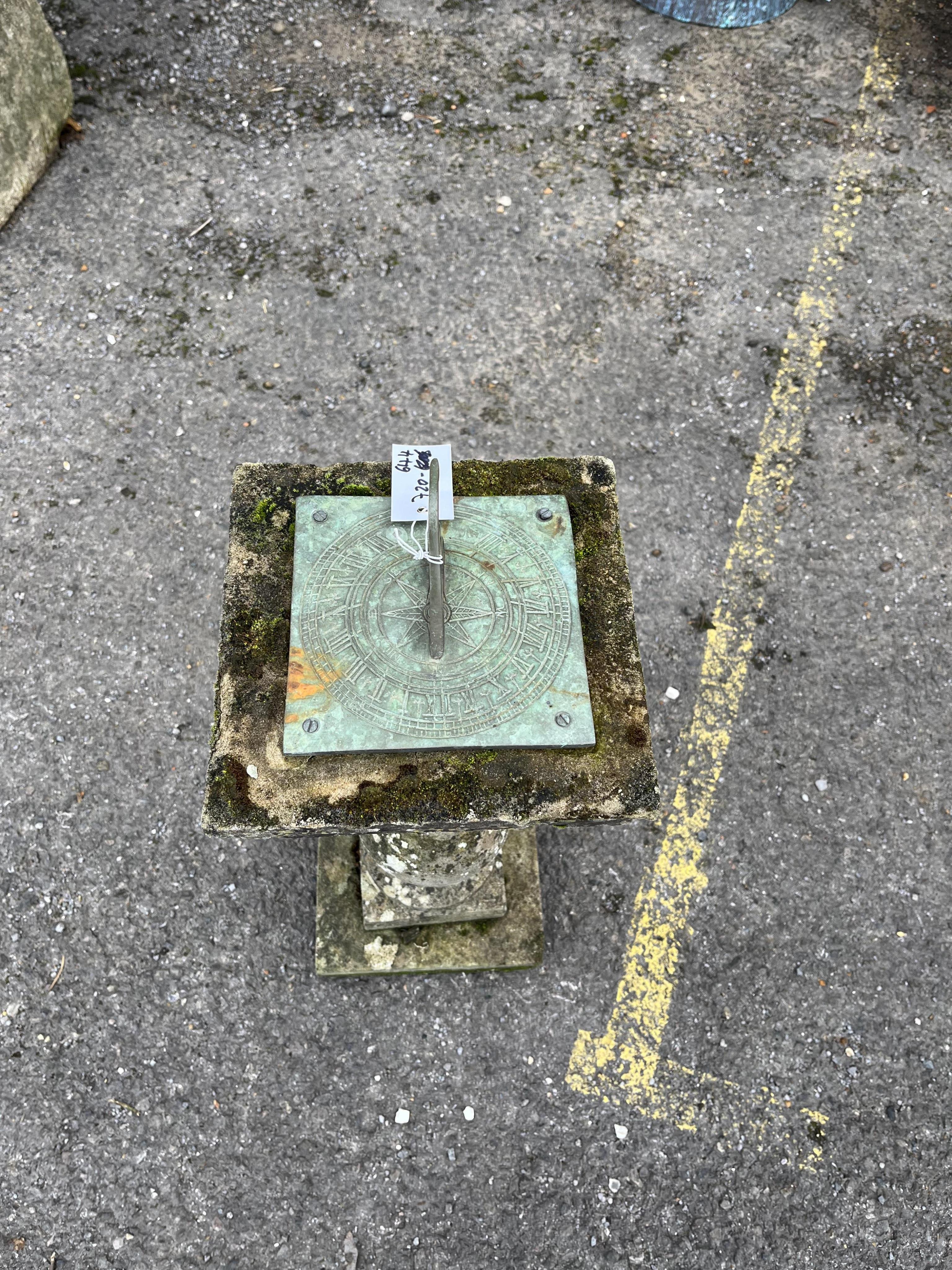 A reconstituted stone sun dial, height 64cm. Condition - weathered, otherwise good